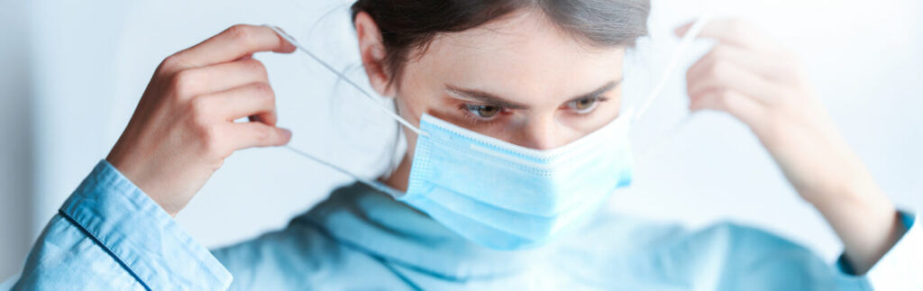 Woman putting on a face mask